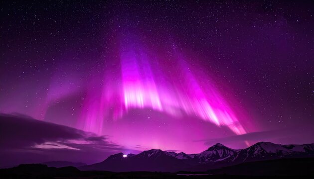 Vibrant purple aurora borealis streaks across a night sky over a mountain range