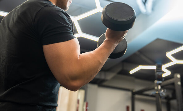 Person exercising in a modern gym environment, using fitness equipment to improve strength, endurance, and overall physical health through structured workout routines.