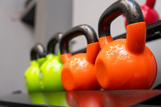 Dumbbells and kettlebells arranged in a modern gym, highlighting strength training equipment used for fitness, bodybuilding, endurance, and functional workout routines.