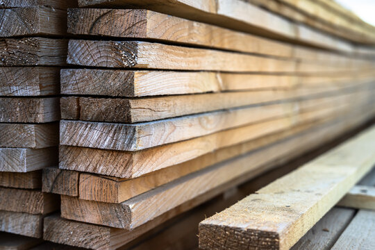 Wood processing workshop producing construction materials, featuring cutting, shaping, and preparing timber for building projects, representing industrial manufacturing and carpentry work.