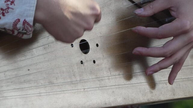 Gusli playing music hands perform on traditional folk instrument