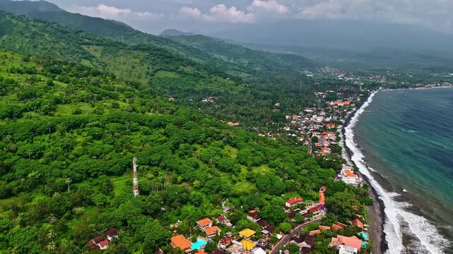 Amed Beach Bali aerial, green hills, coastal village, ocean waves