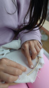 Focused shot highlighting skilled tailors sewing with tools