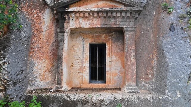Ancient Lycian tomb carved into a rocky cliff on Kastellorizo island