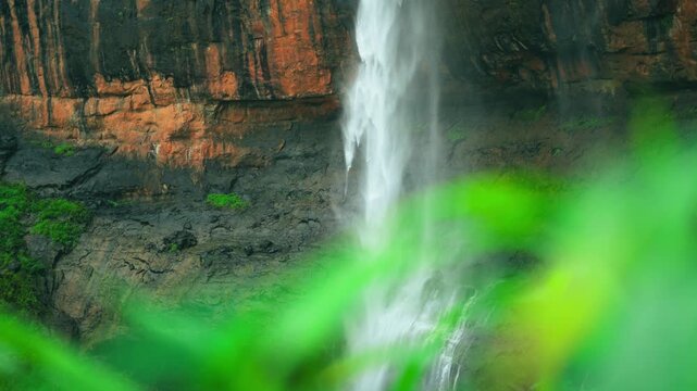 4K Closeup slow motion shot of waterfall hitting the ground during the monsoon season as seen from the forest at Kaataldhar waterfall near Lonavala in Maharashtra, India. Waterfall in monsoon season.