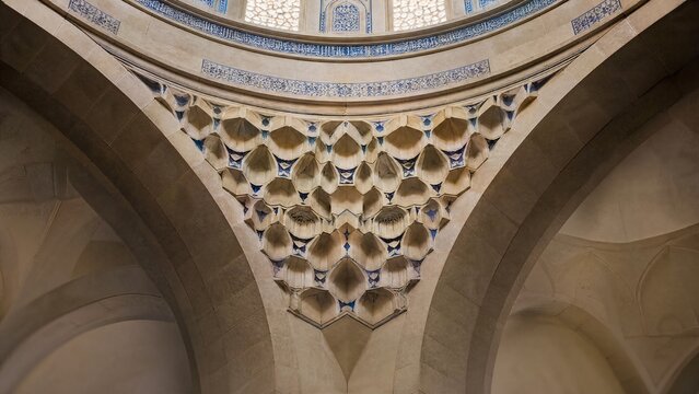 Islamic architectural interior with geometric patterns under a dome, soft ambient light.