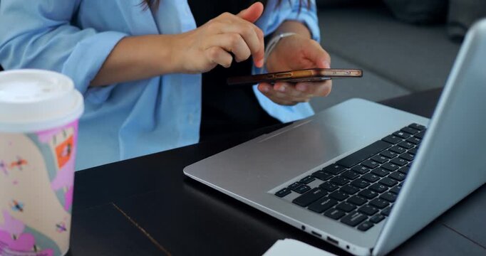Remote worker managing multiple devices. Individual balancing phone and computer tasks seamlessly. Modern professional engaging with digital communication tools while working remotely