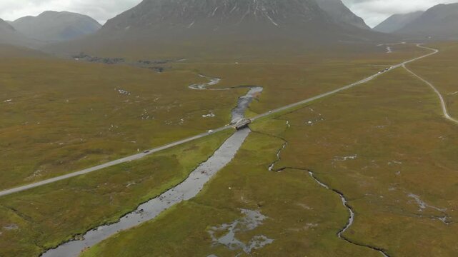 Drone reveal of Buachaille Etive Mor, A82 road and river, Glencoe.
