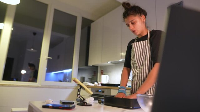 Woman in contemporary kitchen practicing pastry making methods