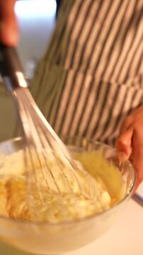 Steady wrist and warm light enhance dessert preparation