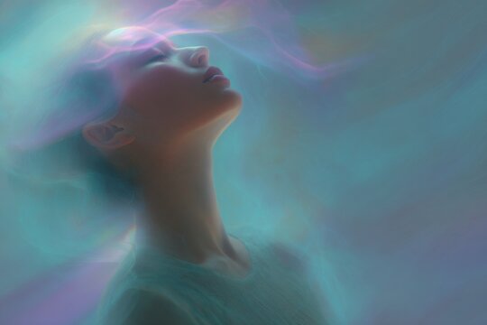 Closeup woman exhaling spirals of shimmering aurora breath for mindfulness background and meditation poster with dreamy pastel light and ethereal atmosphere