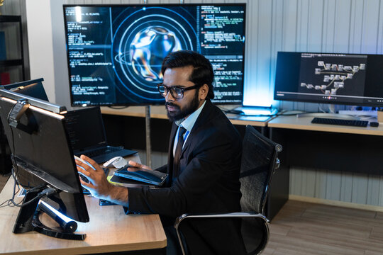 IT director holds tablet while analyzing global cyber code network data inside security operation center command