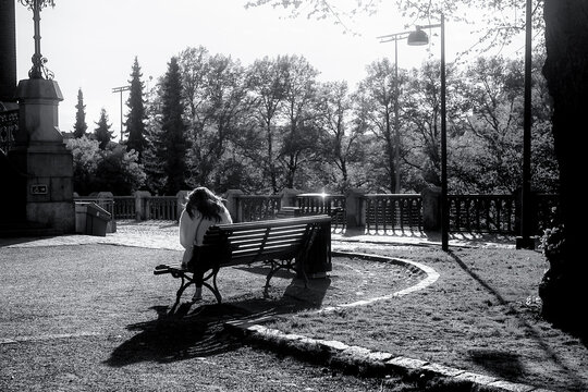 Woman Sitting on a Bench in Evening Sunlight