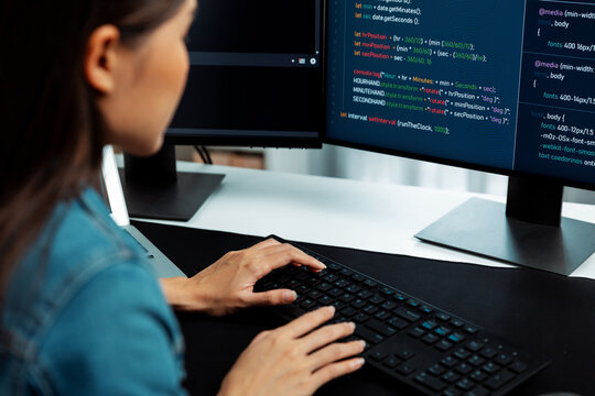 Young Asian in IT developer creating with typing online information on pc with coding program data of website application, wearing jeans shirt. surrounded by safety analysis two screens. Stratagem.