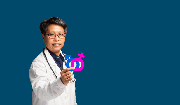 Doctor holding gender symbols for reproductive health