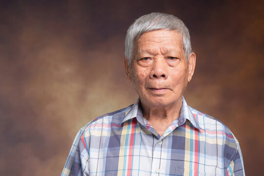 Senior man portrait against neutral studio background
