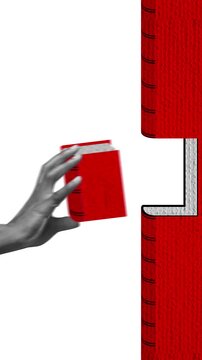 Grayscale hand holding red books in stop motion near oversized stacked books. Concept of learning, knowledge management, education, corporate training, publishing and information access.