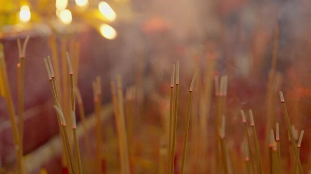 The incense burner with many incense sticks placed inside, the beautiful smoke rising represents a request to the divine.