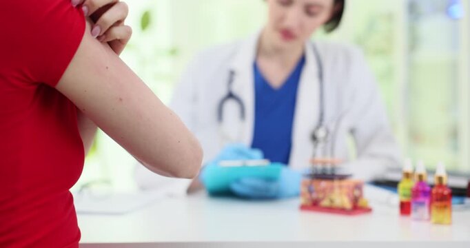 Woman scratches itchy skin as doctor analyzes disease development in dermatology clinic. Medic listens to patient and plans treatment in hospital