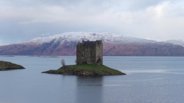 Iconic castle stalker sitting on an islet in a scottish loch