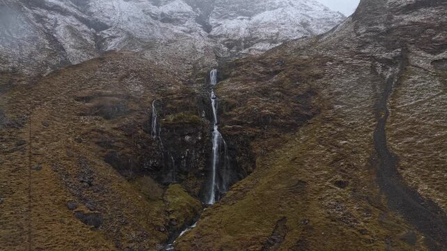 Scenic waterfall cascading down glen coe mountains in scotland