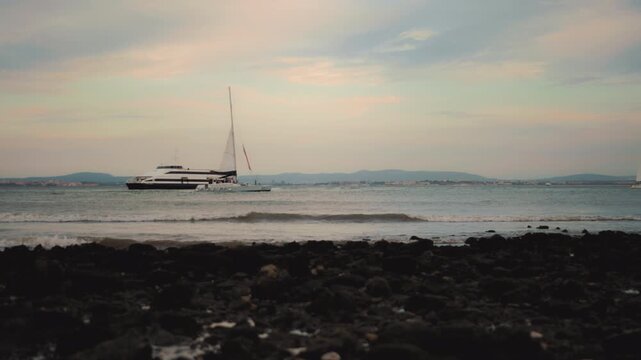 Luxury motor yacht speeding through the blue water of Tagus river estuary in Lisbon