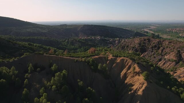 Settlement near Setti Fatma in the Ourika Valley, Al Haouz Province, Marrakesh Safi, Morocco, featuring Berber hillside villages, riparian vegetation and eroded High Atlas forward flyover aerial