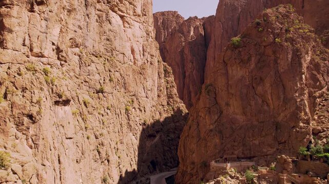 Todra Gorge near Tinghir, Dr&acirc;a Tafilalet, Morocco, featuring vertical limestone canyon walls carved by the Todgha River within the eastern High Atlas region, forward flyover drone shot