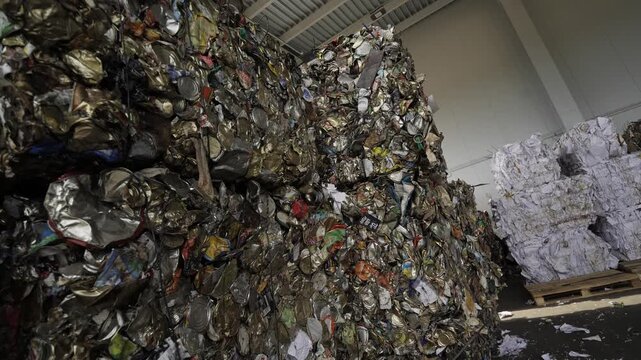 Garbage Recycling Factory, Plastic cubes for recycle Plant, Bales of pressed boxes, rubbish warehouse collection. Preparation of recyclables for recycling, Plastic city garbage.