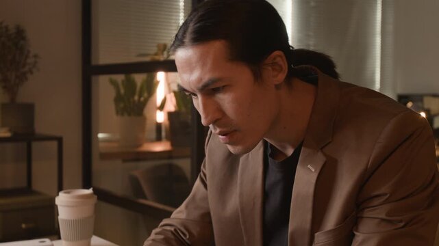 Asian young programmer typing on laptop at office desk, celebrating success, smiling and clapping hands. Video for software development and IT startup marketing campaigns