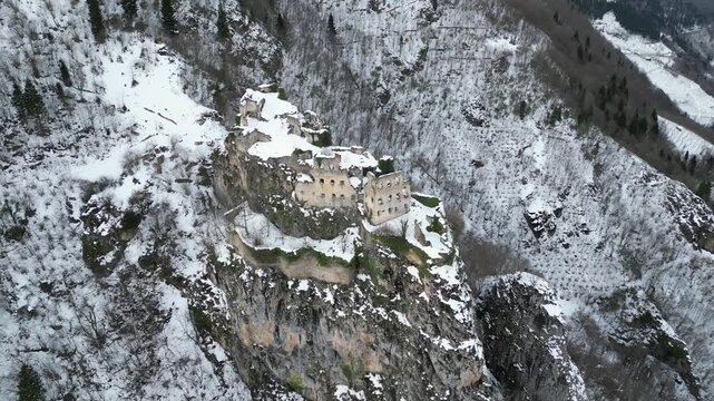 Beautiful winter landscape with historical Kustul Monastery ruins under cinematic sunlight.