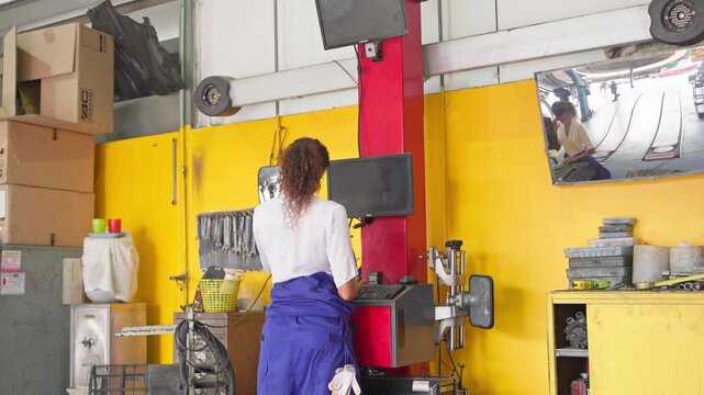 Automotive maintenance procedure tire shop instructional video industrial setting overhead view practical skills
