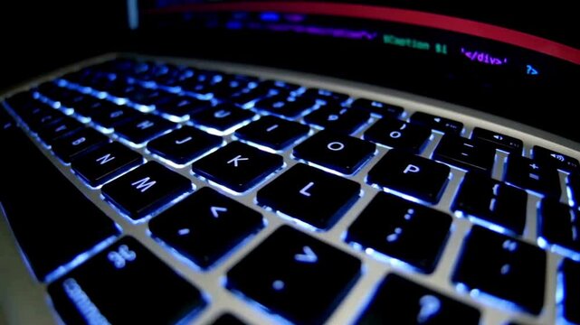 Close-up of glowing blue keyboard, computer keyboard with blue backlight, illuminated keyboard keys, glowing keyboard