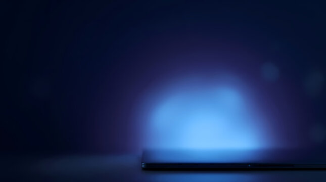 Sleek Laptop Edge On Minimalist Midnight Navy Background With Fading Indigo Blue Glow And Elegant Bokeh Effects