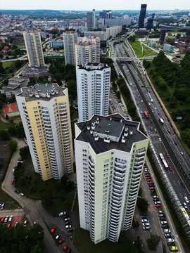 Vertical aerial drone view of the iconic Gwiazdy star-shaped residential skyscrapers and heavy highway traffic in Katowice, Poland.