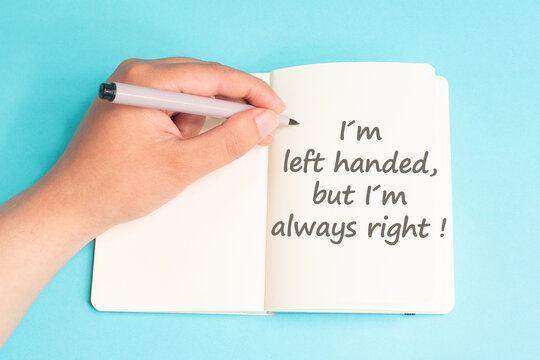 Left handed but I am always right standing on notebook, writing with left hand, pen and table, lefty concept, handwriting a message