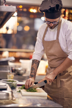 Chef prepare prasley .Cook in Professional Modern  kitchen, restaurant concept