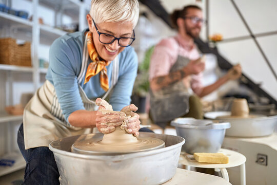 elderly woman artist making pot from wet clay. Business, art, Creative, hobby ,workshop  concept