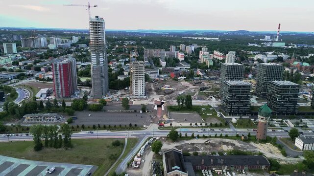 High angle wide aerial panorama of modern skyscraper construction and luxury apartment buildings in the developing urban area of Katowice, Poland.