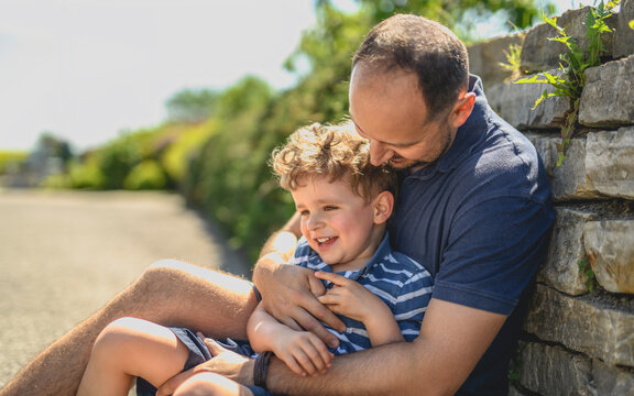 boy crying with his son outdoors in urban place