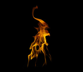 Fototapeta premium A vibrant isolated fire flame burning with orange and yellow hues against a pitch-black background. This high-quality dynamic blaze is perfect for creative composite designs, overlay effects.
