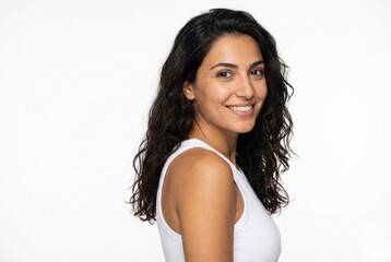 Fototapeta premium Beautiful brunette woman with wavy hair smiling on white background