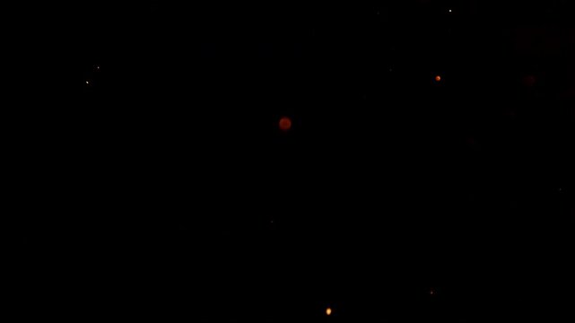 Flying Sparks Isolated on Black Background. Filmed on High Speed Cinema Camera