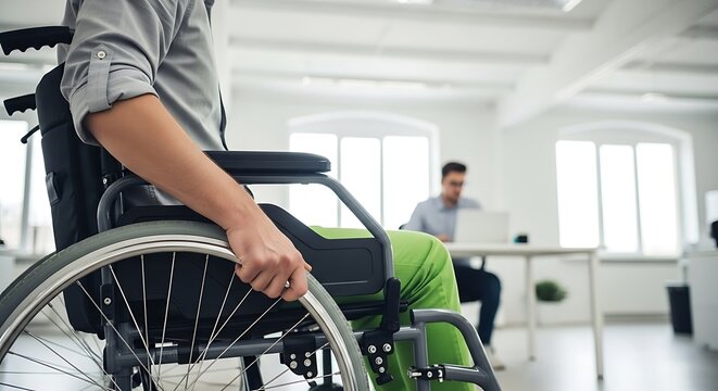 Man in Wheelchair Working in Bright Modern Office with Colleague