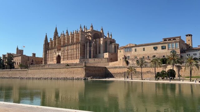 La Seu Cathedral in Palma de Mallorca reflected in calm waters, showcasing magnificent Gothic architecture and the rich cultural heritage of the Mediterranean.