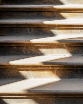 Sunlight Casting Long Shadows on Old Stone Staircase Steps stairs