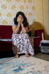 Fototapeta premium disappointed young woman expressing anxiety and emotional distress in living room