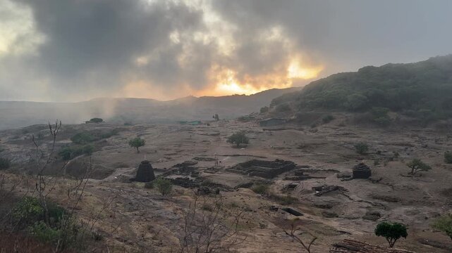 Amazing misty cloud movement during dawn at Harishchandragad temple complex. 