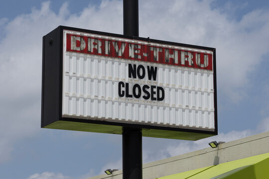 Now Closed sign on an out of business and deserted restaurant. Inflation is causing customers to find cheaper eateries.