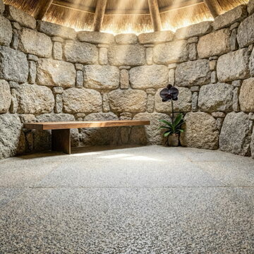 Minimalist Palloza Interior with Negative Space and Granite Wall
